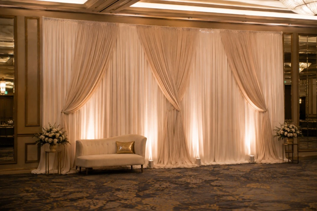 Elegant event photo area with fabric backdrop and realistic venue lighting