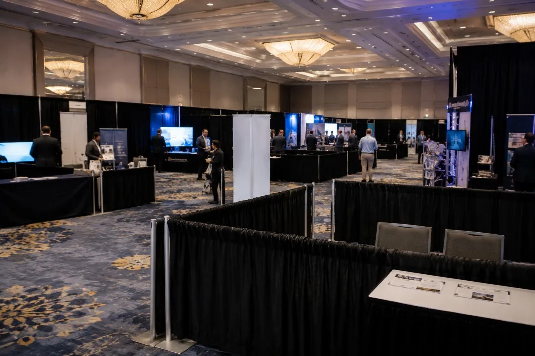 Pipe and drape booth divisions inside a professional trade show environment