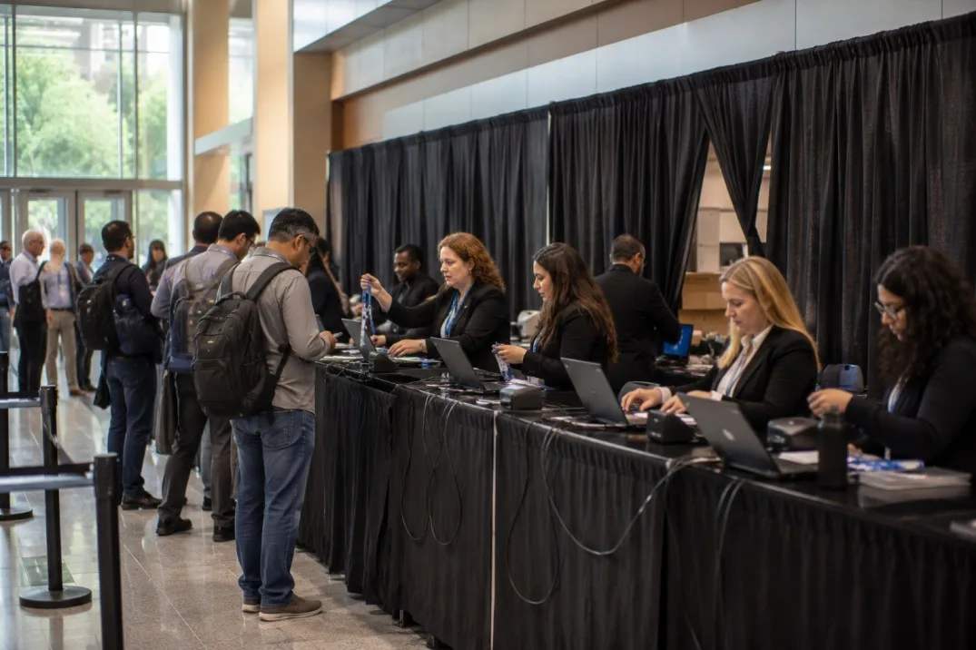 Illustrative trade show registration area organized with temporary fabric draping