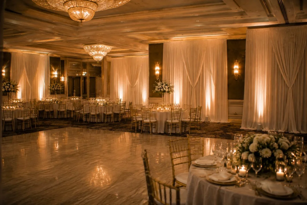 Wedding reception ballroom with floor to ceiling ivory draping